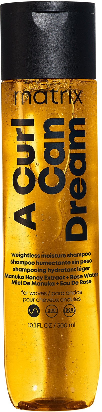 Eine gelbe Flasche mit der Aufschrift 'A Cure Can Dream' enthält Shampoo, schwarze und rote Schrift, schwarzer Korken.