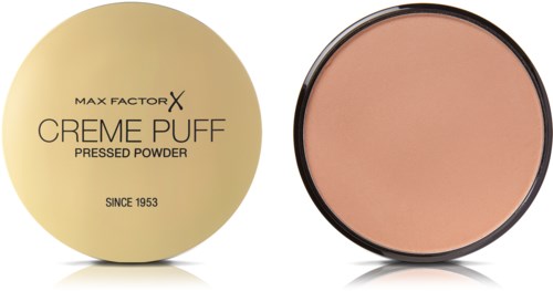 En rund behållare med beige puder och ett guldlock märkt Max Factor Creme Puff pressat puder.