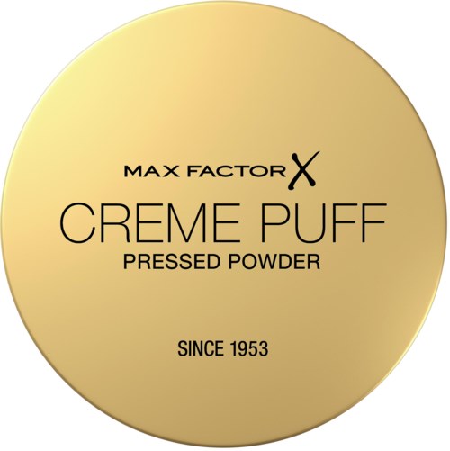 Kultainen pyöreä rasia, jossa musta teksti mainostaa Max Factor X Creme Puff -puuteria vuodesta 1953.