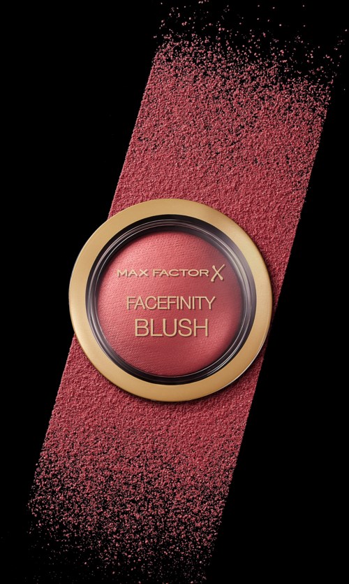 Een blush-product genaamd Max Factor X Facefinity met roze poeder rondom een ronde container op een zwarte achtergrond.