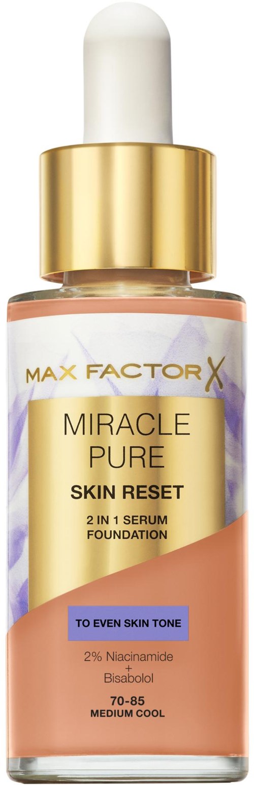 A skincare serum bottle with a white dropper cap, gold collar, and pastel-colored label for skin tone matching.