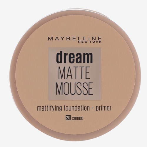En rund kosmetikbehållare med beige och grå färger, märkt 'Maybelline Dream Matte Mousse,' innehållande grund- och primerprodukt.