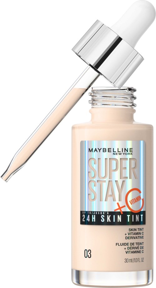 Beige purkkia, jossa tippojen kantaja, sisältää Maybelline Super Stay Skin Tint. Etikassa lukee tuotetiedot ja merkin nimi.