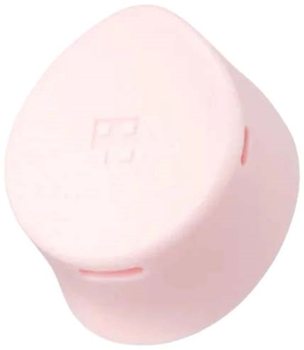A round pink container with a subtle logo embossed, possibly a beauty or skincare product.