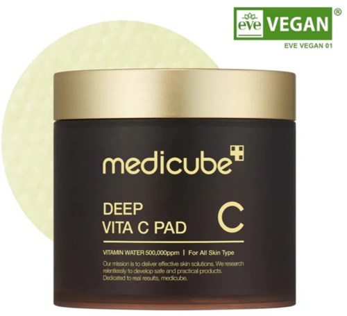 Vegan dyp vitamin C ansiktspute i krukke med gulllokk, etiketten nevner fukt, hudpleie og sikkerhet. Logo og tekst.