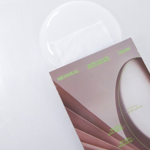 Medicinal cream packaging next to a clear glass plate on a white surface.