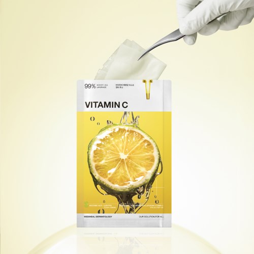 A vitamin C supplement packet with a lemon image, a dropper, and a hand holding a cotton swab.