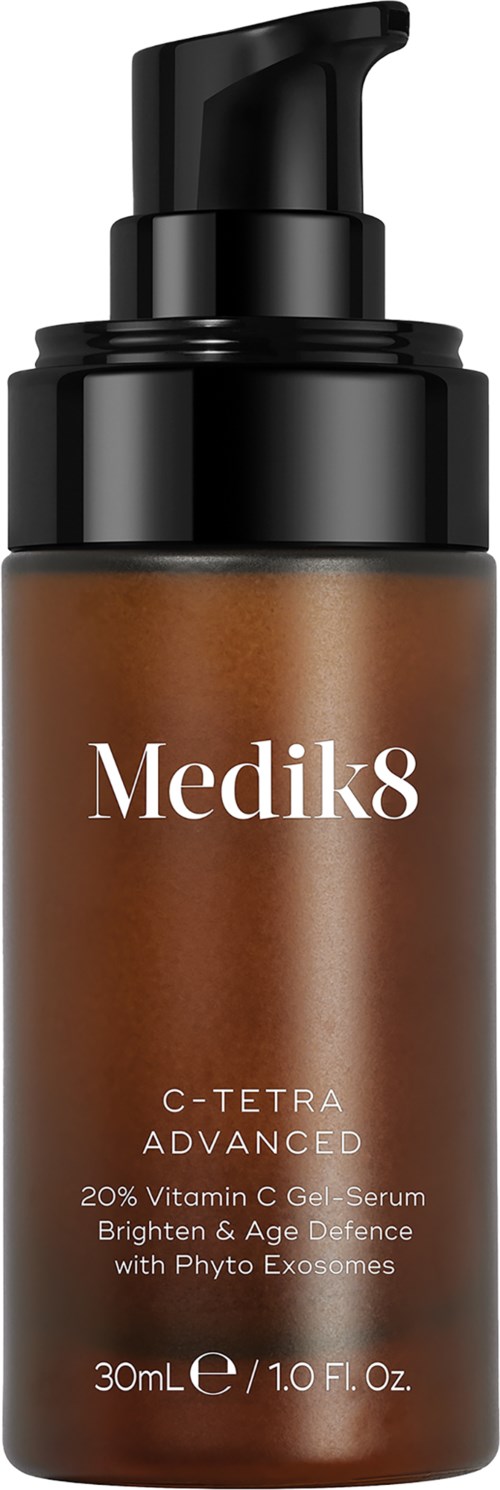 A brown skincare bottle with a black pump, labeled Medik8 C-Tetra Advanced, containing vitamin C serum for brightening skin.