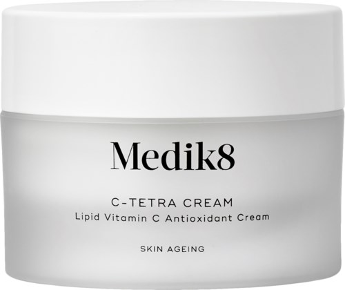 A white jar with black text promoting Medik8 C-Tetra Cream, a vitamin C antioxidant for skin aging.