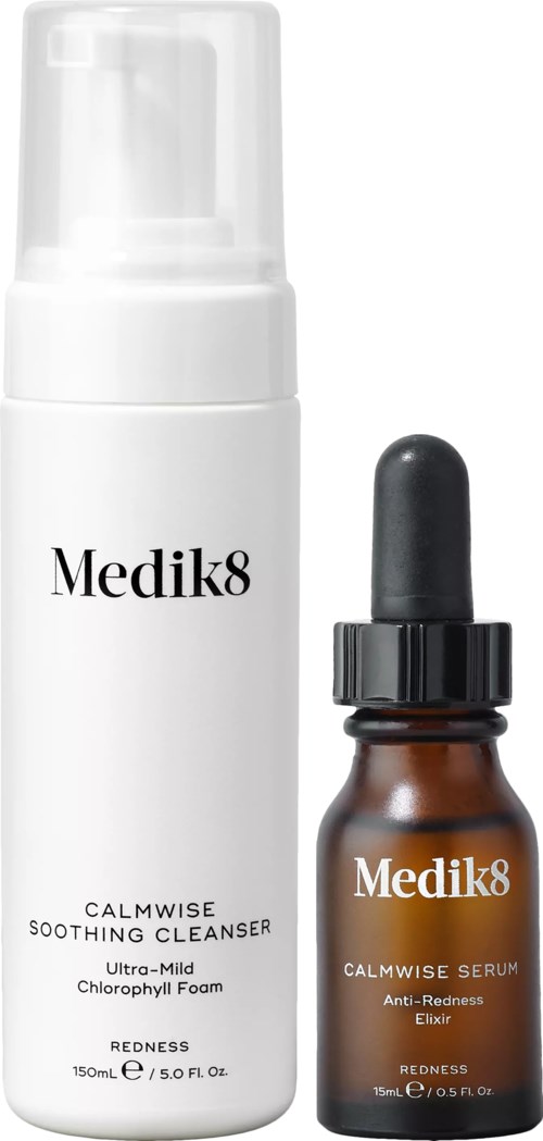 A white bottle of Medik8 calming cleanser and smaller brown bottle of Medik8 serum with dropper.
