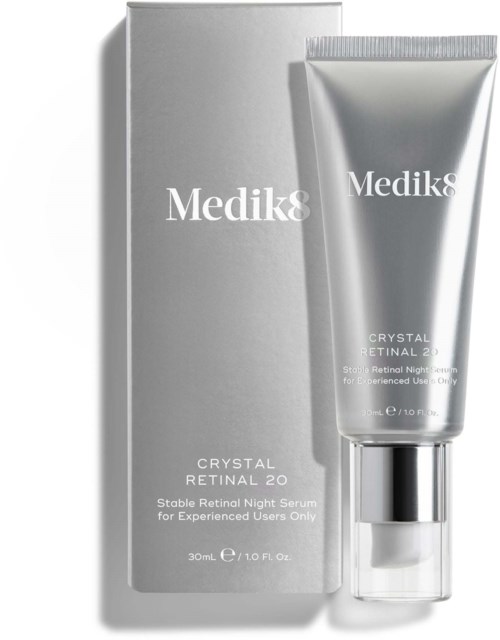 A silver tube of night serum with a silver cap, next to a white box, labeled Medik8 Crystal Retinal 20.