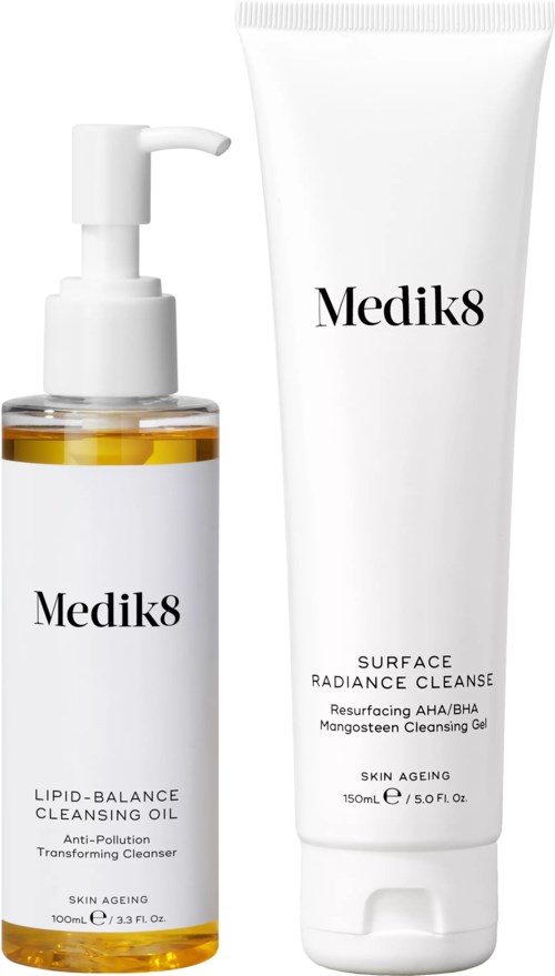 Two skincare products, one in a pump bottle and one in a tube, both labeled Medik8 for cleansing and skin care.