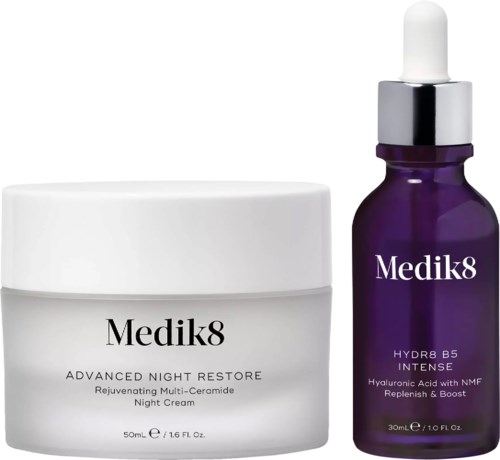 Two skincare products: a white jar of night cream and a purple dropper bottle of serum.