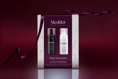 Medik8 skincare products in a box with a dark purple background and a purple ribbon.