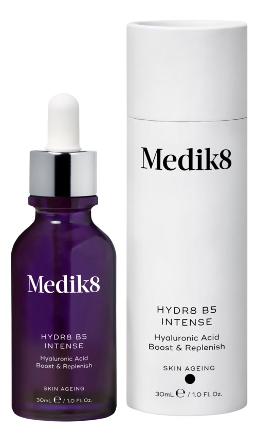 A purple bottle with a dropper and a white cap beside a white cylindrical container, both labeled Medik8 for skin care.