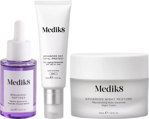 Three skincare products in white containers, including a serum, moisturizer, and night cream from Medik8.