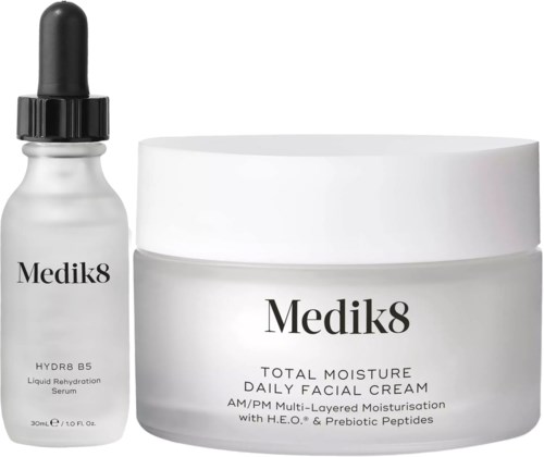 A bottle of hydration serum and a jar of facial cream from Medik8 for skin moisture and care.