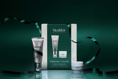 Medik8 Nighttime Yourish skincare set with cream, serum, and moisturizer in green and white packaging, decorated with black ribbon.