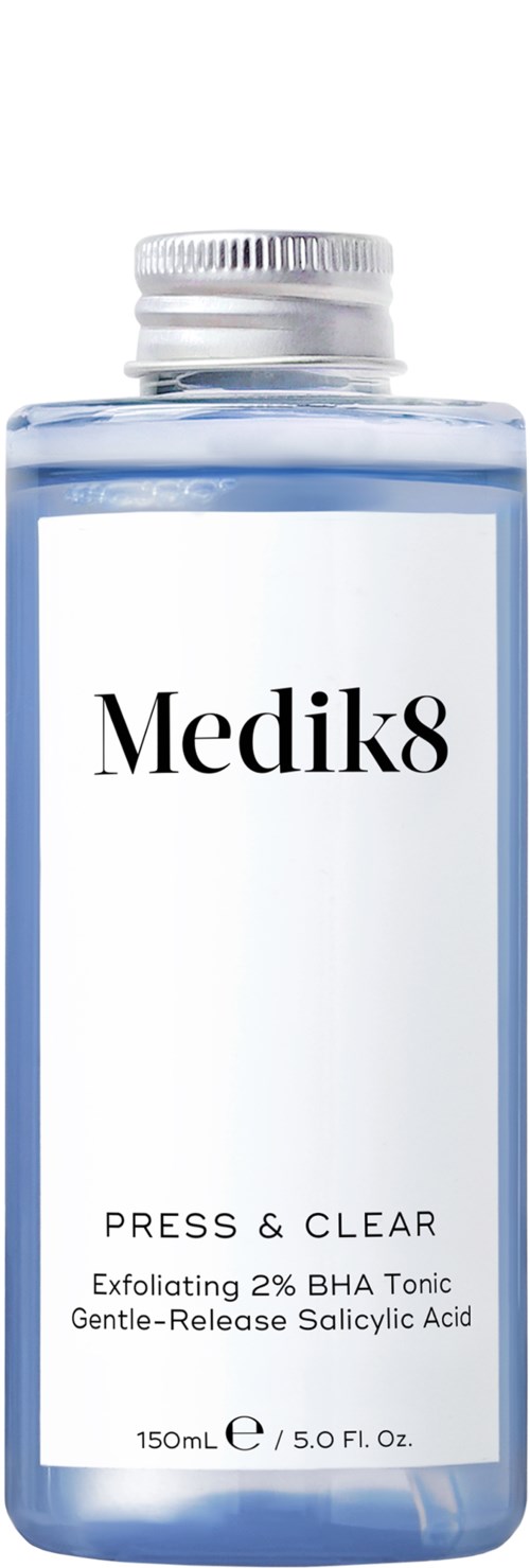 A blue bottle with a silver cap, labeled 'Medik8,' contains skincare product with exfoliating ingredients.