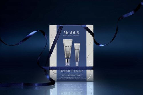 Medik8 Retinal Recharge skincare set with two tubes, presented in a box with dark blue ribbons around it.