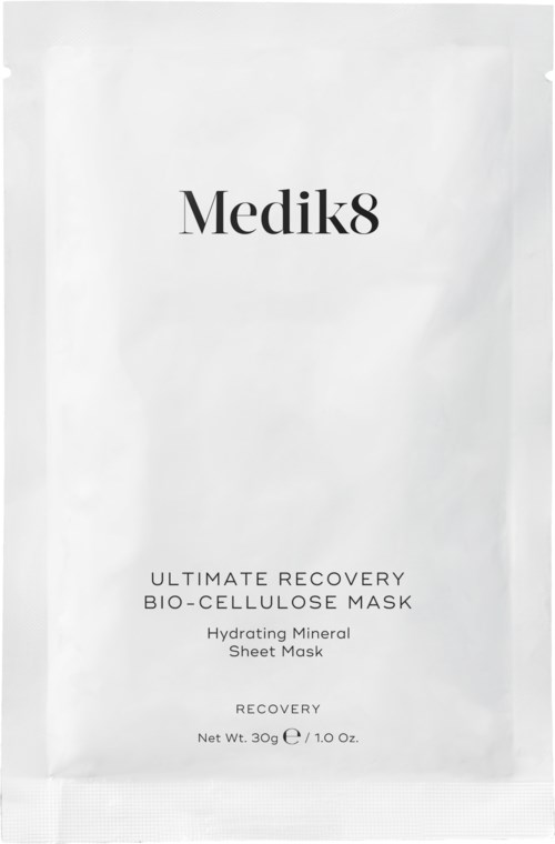 A white packet labeled 'Medik8' with text about a hydrating face mask and recovery benefits.