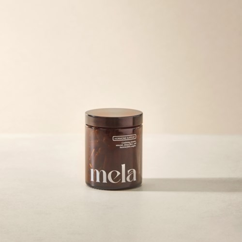 A brown container with a lid, labeled 'mela' on the front, placed on a white surface.
