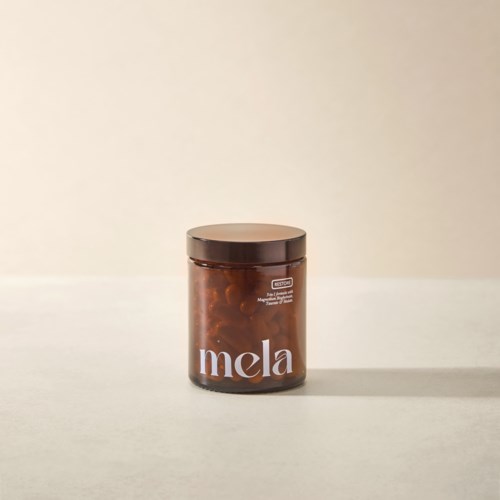A brown jar labeled "mela" sits on a plain surface with a simple background.