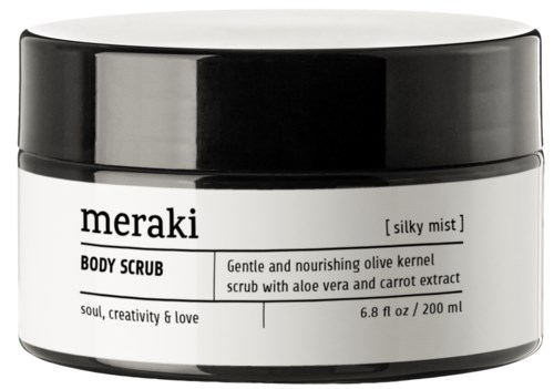 Ein weißer Behälter mit schwarzem Deckel enthält Meraki-Körperpeeling, bezeichnet als nährend mit Olive, Aloe und Karottenextrakt.