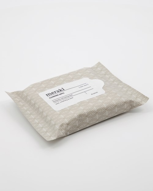 A wrapped package with a label showing the brand 'meraki' and some product information.