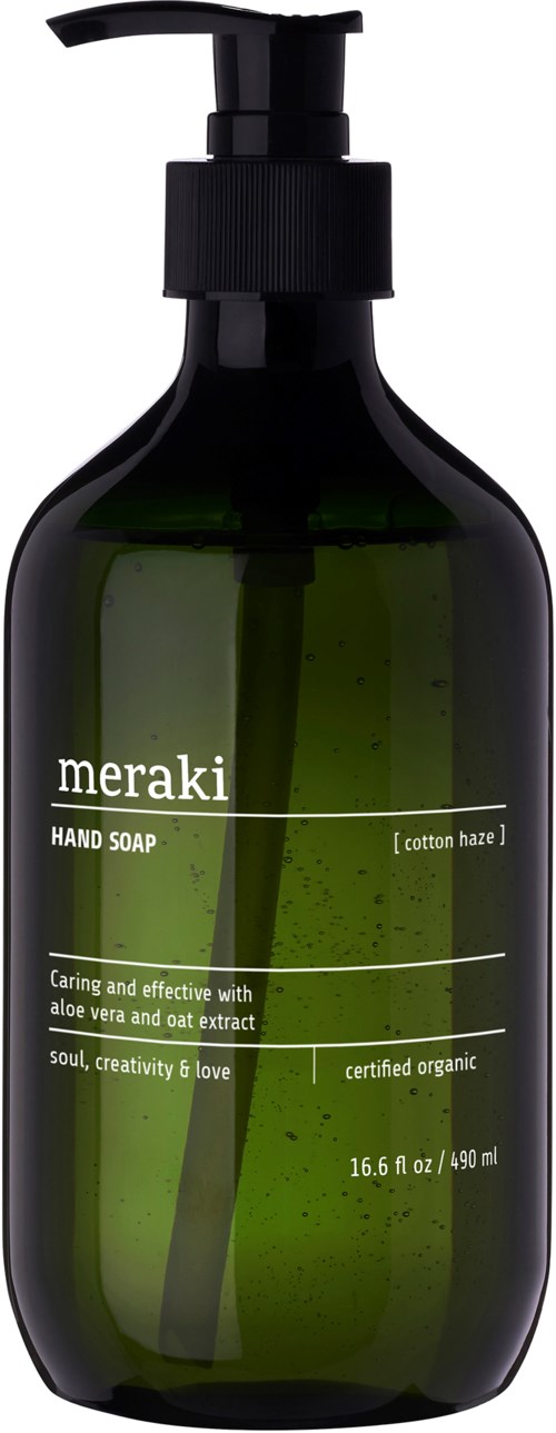 A dark green bottle with a black pump contains Meraki hand soap with cotton haze scent. It highlights organic ingredients and is 16.6 oz.