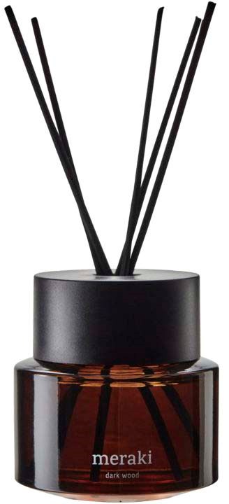 A dark wood scented candle with black reed sticks in a black and brown container.