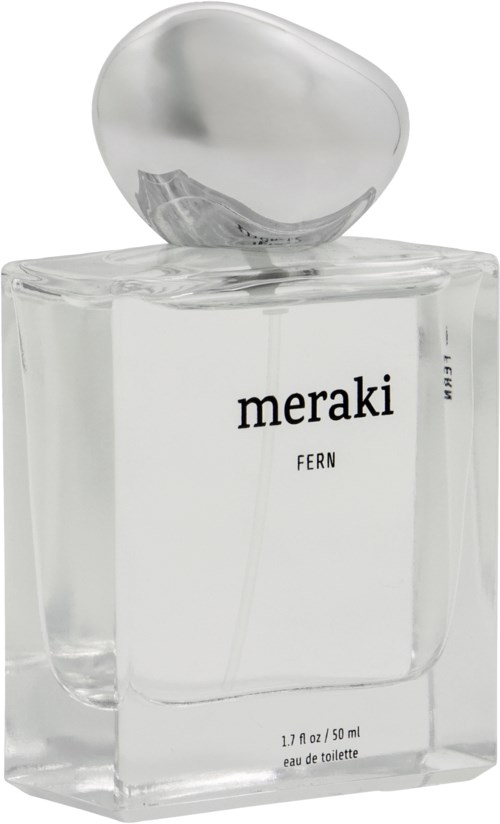 A clear perfume bottle with a silver cap labeled 'meraki FERN' and small text at the bottom.