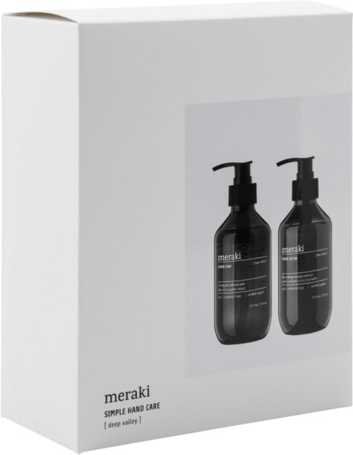 Een doos met twee zwarte flessen Meraki handverzorging, met pomp, op een witte achtergrond.