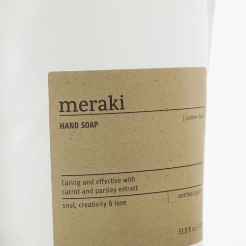 The label shows a natural, eco-friendly hand soap named "meraki" with carrot and parsley extract ingredients.