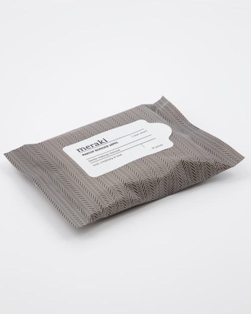 A rectangular package wrapped in patterned paper with a white label on top.