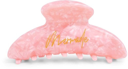 A pink, large hair clip with gold writing that says "Marmalade" on it.