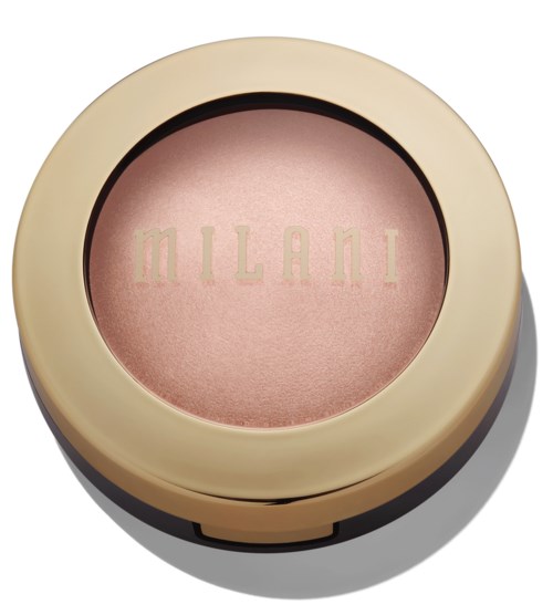 A round makeup compact with a beige case and pink powder inside labeled 'MILANI' inside the lid.