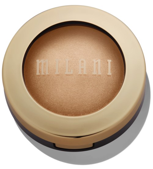 A round makeup compact with beige casing and a bronze-colored powder inside, featuring the brand name 'MILANI' embossed.