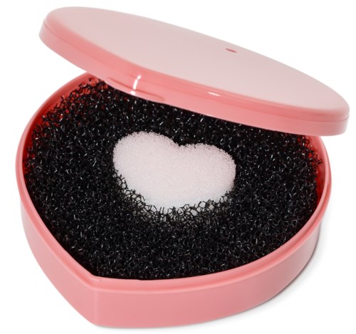 Pink heart-shaped sponge inside a pink container, with a black sponge surrounding it.