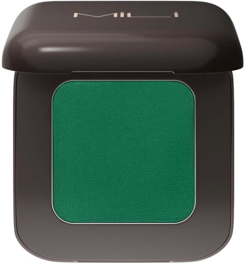 Green eyeshadow in a black compact with a lid that has the word 'MAY' on it.