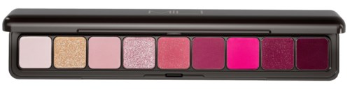 A row of eight pink and red eyeshadow colors in a black palette.