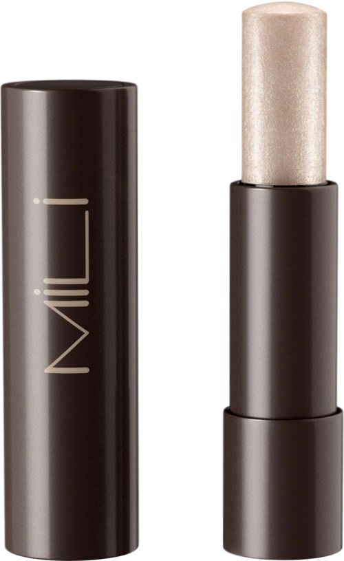 A black stick with a cream-colored tip, labeled 'Milk', appears to be a beauty or skincare product.