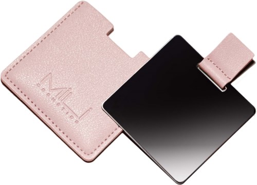 A pink case holding a black makeup mirror with a strap. The case has the word 'Makeup' embossed on it.