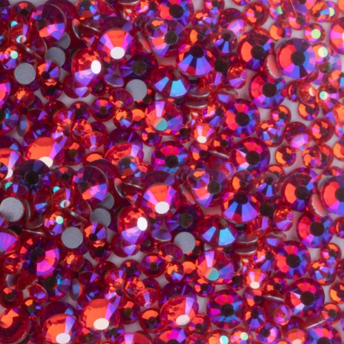 The image shows a close-up of shiny red and purple gemstones or rhinestones densely packed together.