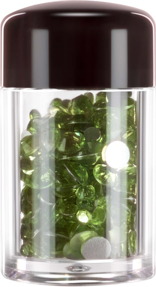 A small transparent container filled with green pills and a white tablet inside.