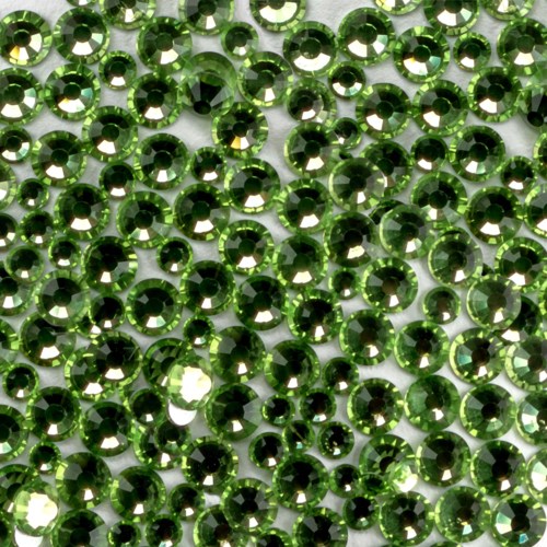 A close-up of many small, shiny, green rhinestones arranged closely together.