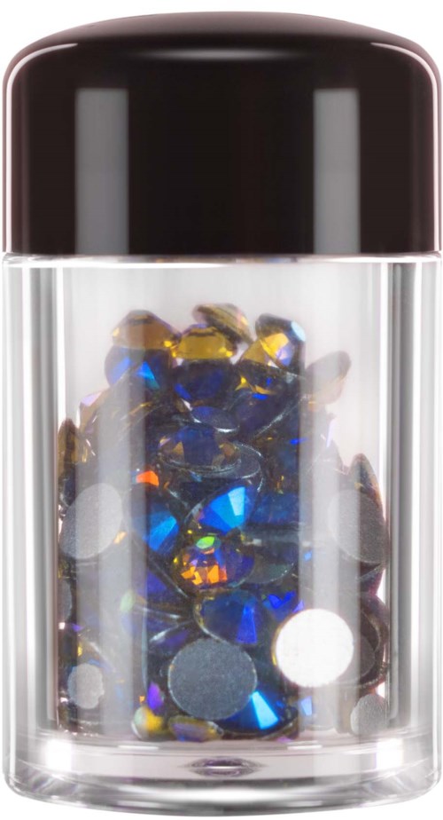 A small glass jar filled with shiny, colorful stones or gems inside.