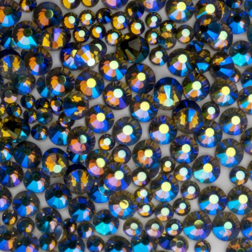 Shimmering collection of small, colorful, reflective crystals creating a sparkling, visually appealing surface.