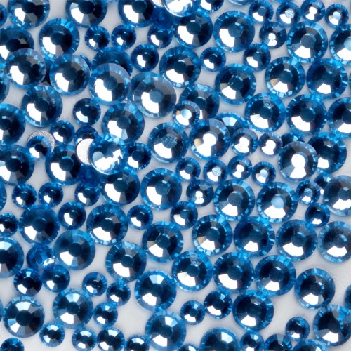 A close-up of many shiny blue circular beads or rhinestones, densely packed together.