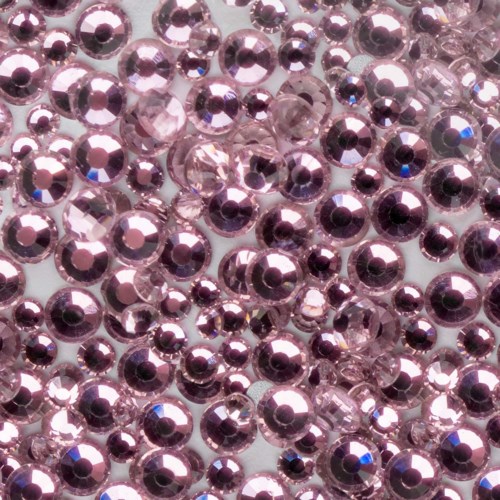 Small, shiny pink beads closely packed together. They look like decorative jewelry embellishments.